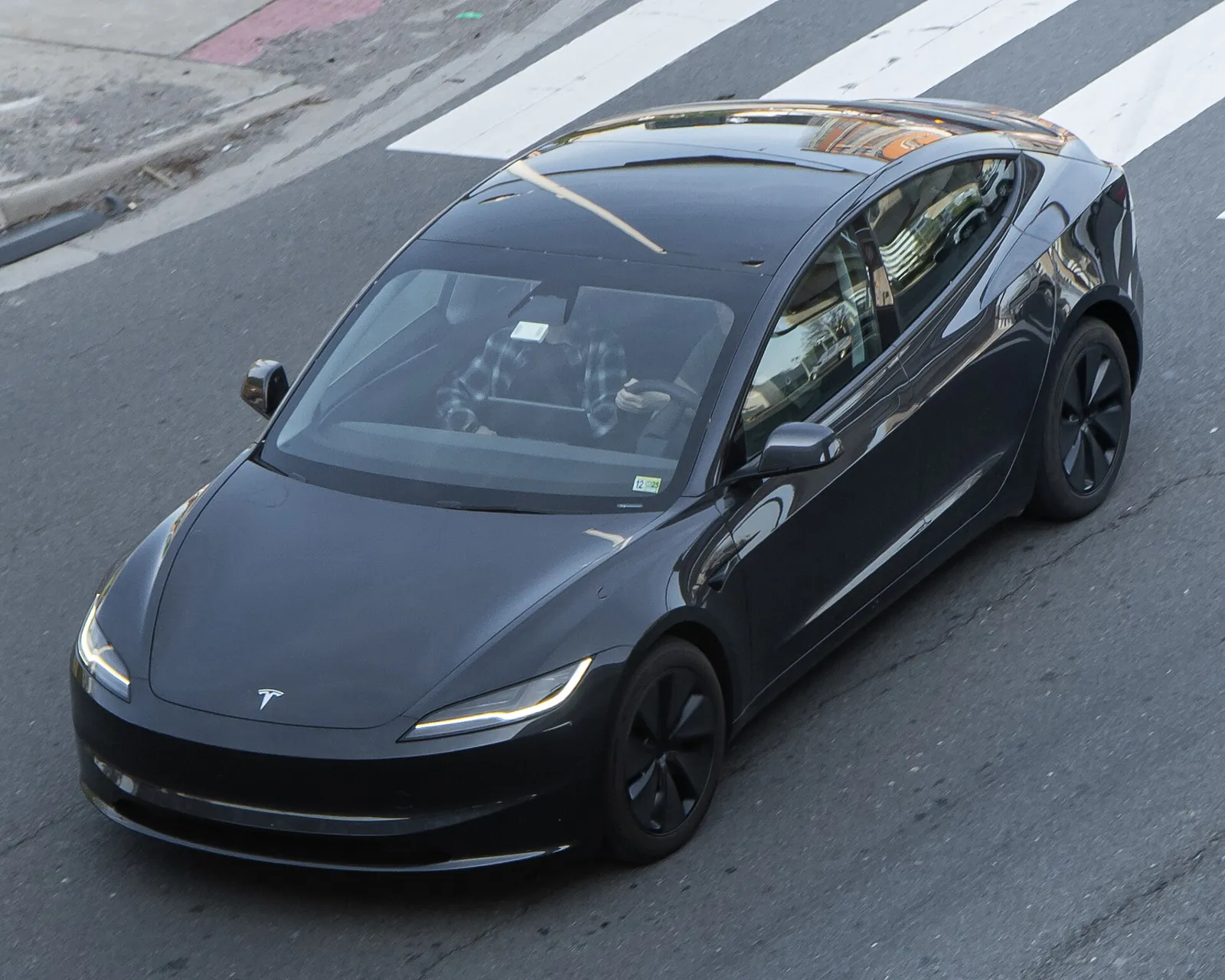 White Tesla Model 3 Highland, front three-quarter view