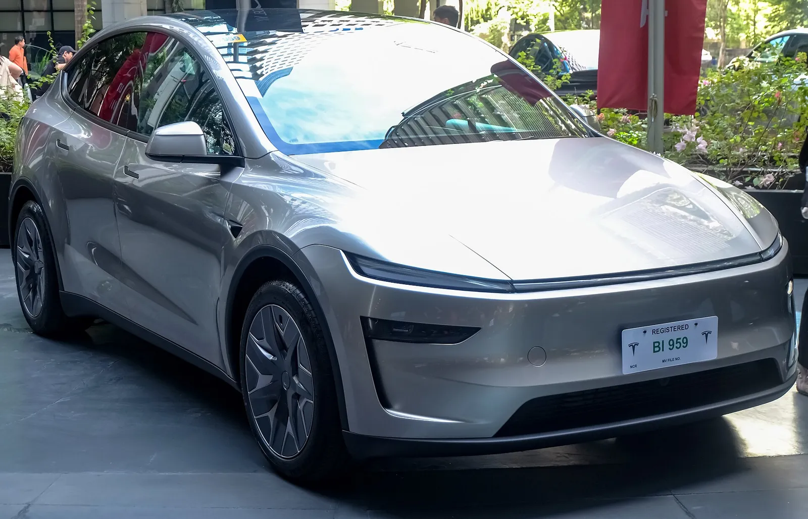 Silver Tesla Model Y L in Cosmic Silver, front three-quarter view
